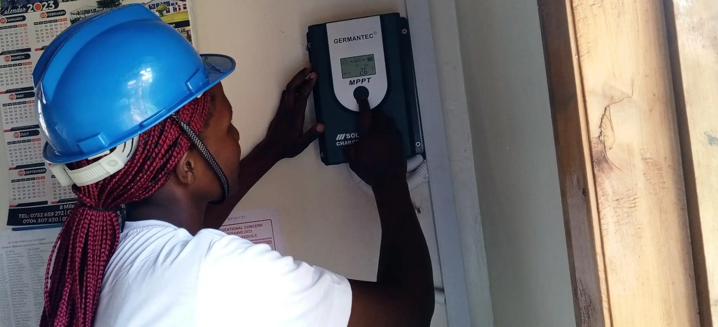 Member of the IEEE Uganda Section installing a solar power system.webp