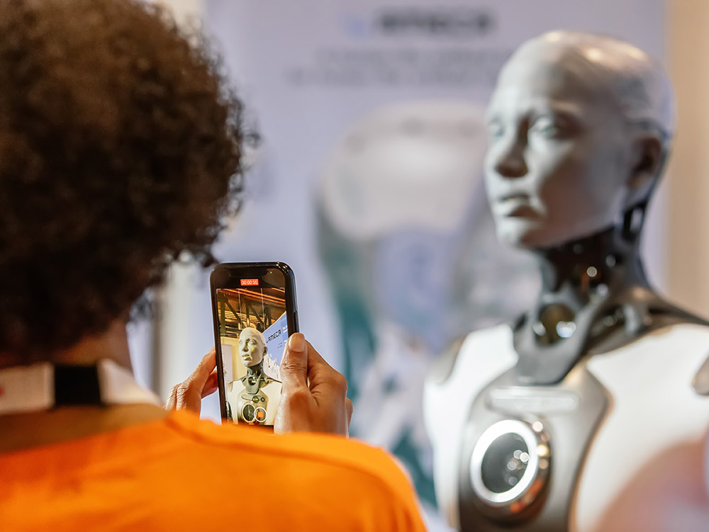 Woman Photographing Robot at ICRA Conference.jpg