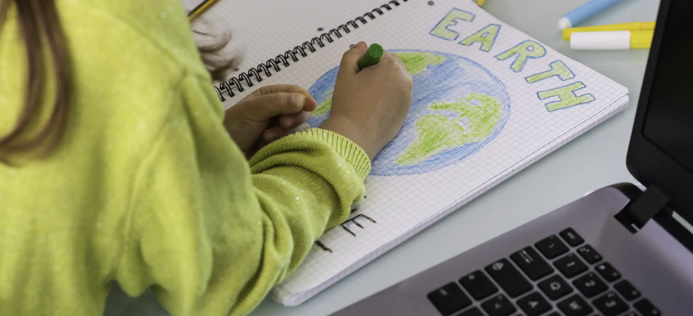 student drawing the earth.webp